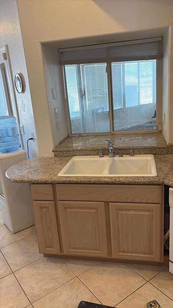 New kitchen base cabinet, granite counter and double sink installed