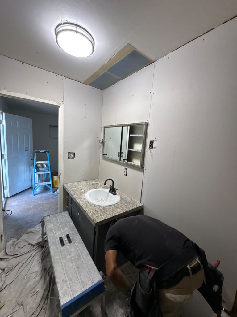 Hanging new drywall around the vanity in a Las Vegas bathroom remodel