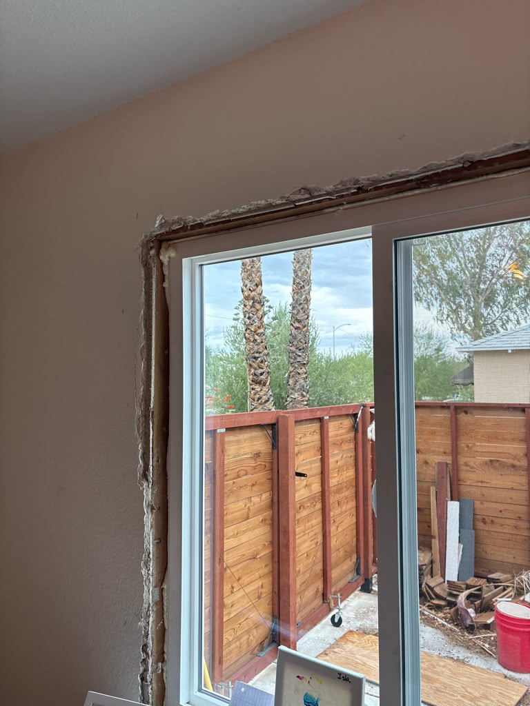 New sliding glass patio door set in a framed opening during installation in Las Vegas