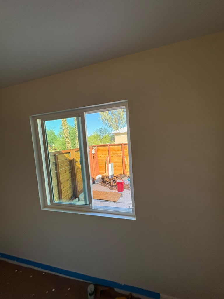 New sliding window after drywall patch and fresh paint in a Las Vegas bedroom