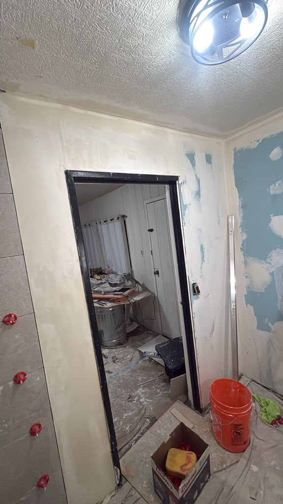 New interior doorway with black trim and skim-coated drywall in a Las Vegas remodel